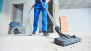 Commercial vacuum cleaning up a room under construction